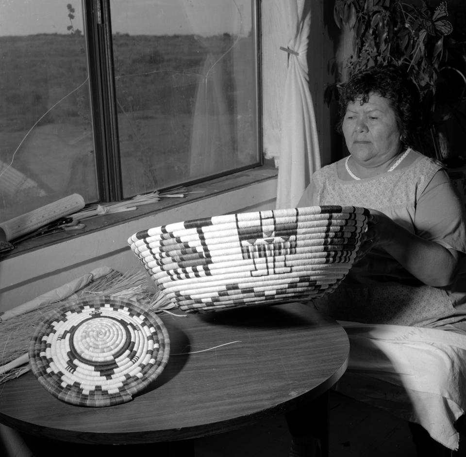 Joyce Ann Saufkie showing an uncompleted large coiled basket
