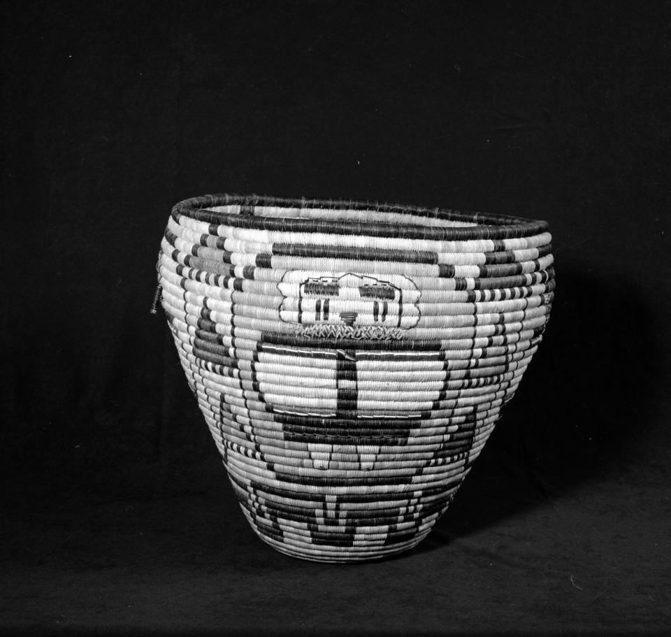 A coiled basket with a Snow Kachina (Nuvaktsinmana) by Pauline Quiyo