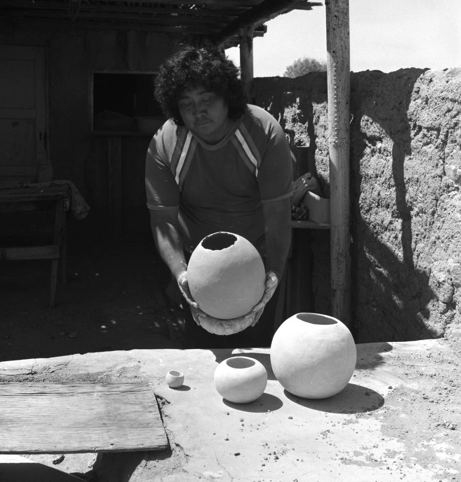 Placing large pot in sun to dry