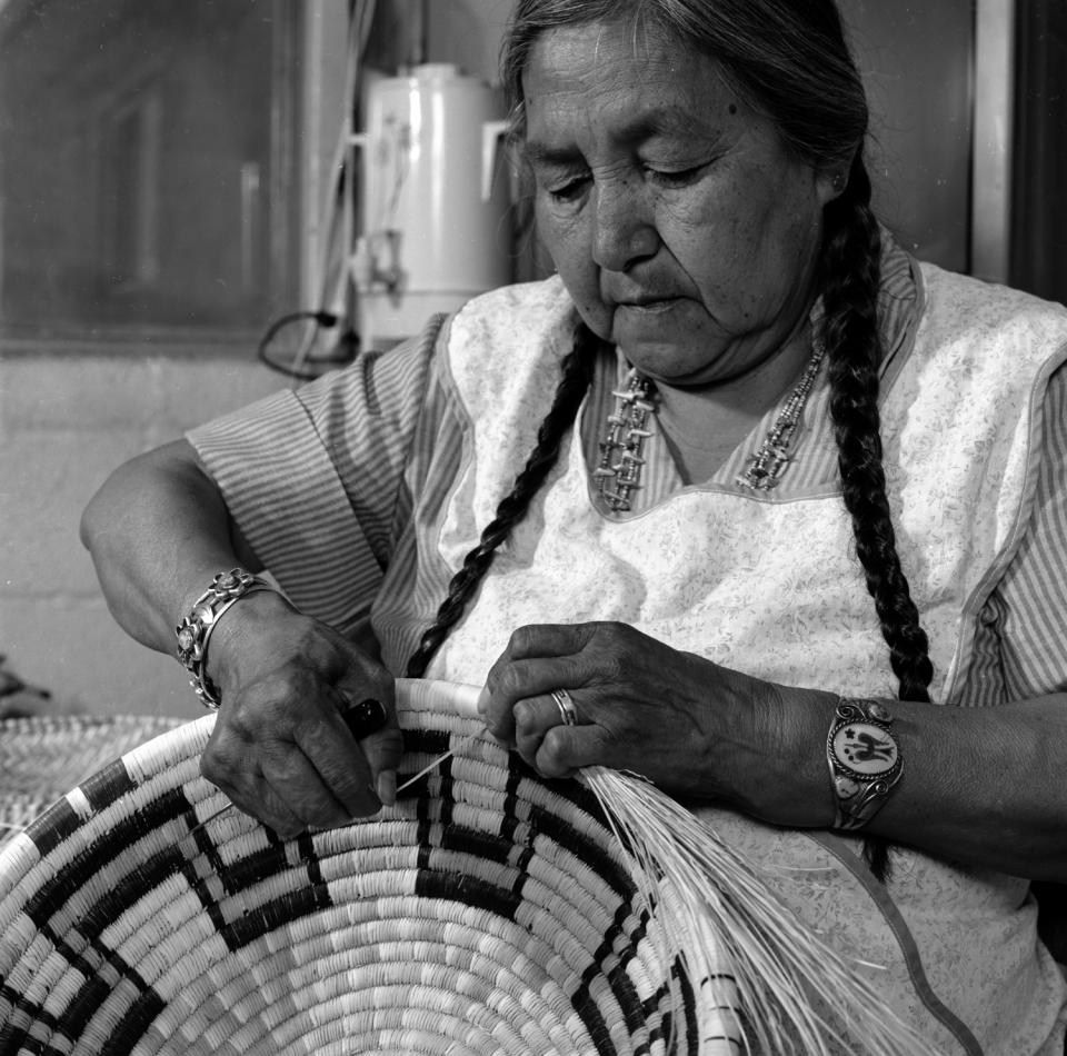 Annabelle Nequatewa working on a coiled basket