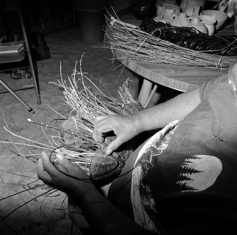 Evelyn Selestewa weaving a wicker fruit basket